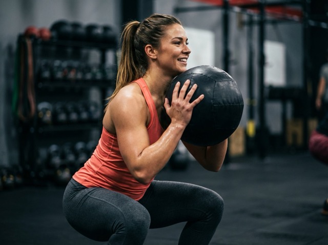 Athlete training with medicine ball